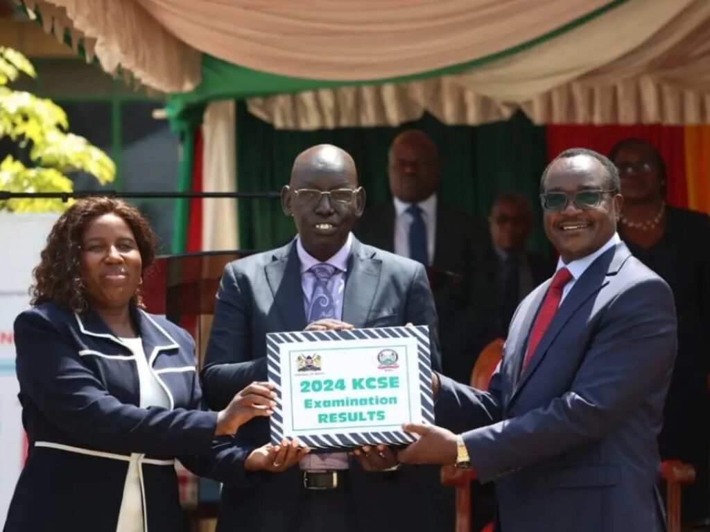 Former Education PS Dr. Belio Kipsang (center) and CS Julius Ogamba (right) preside over the release of the 2024 KCSE exam results.