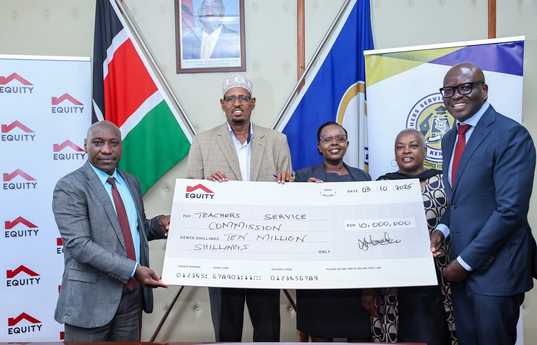 The Chairperson of the Teachers Service Commission (TSC), Dr. Jamleck Muturi, receives a cheque of Ksh 10 million from representatives of Equity Bank. (Photo: TSC)
